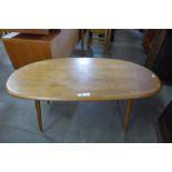 An Ercol Blonde elm topped coffee table, on associated beech legs