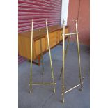 A pair of brass easels, 104cms h