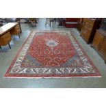 A large red ground rug, 353 x 247cms