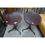 A pair of mahogany oval tilt-top wine tables