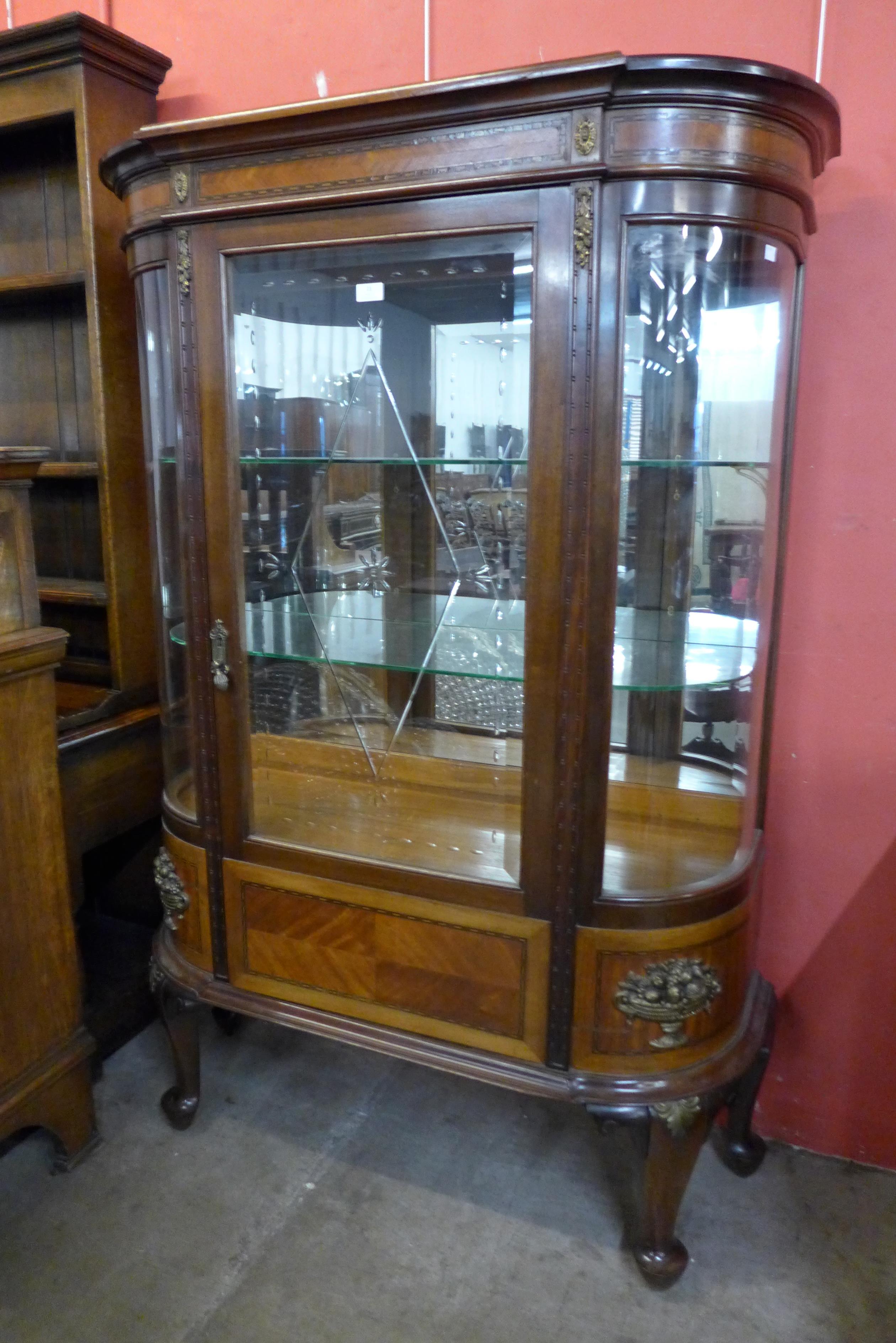 A French Louis XV style bow front mahogany display cabinet