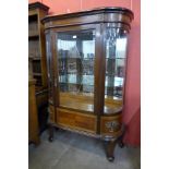 A French Louis XV style bow front mahogany display cabinet