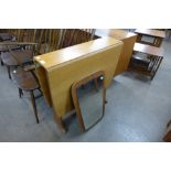 A teak drop leaf table and a teak framed mirror