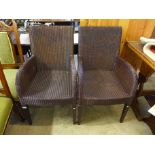 A pair of rattan armchairs