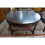 An early 20th Century oak and leather topped drum shaped library table