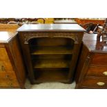 A carved oak open bookcase