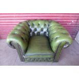A green buttoned leather club chair