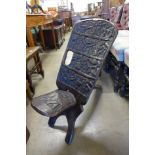 An African carved hardwood birthing chair