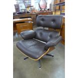 A Charles & Ray Eames style simulated rosewood and brown leather revolving lounge chair