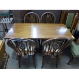 A beech refectory table and four wheelback chairs