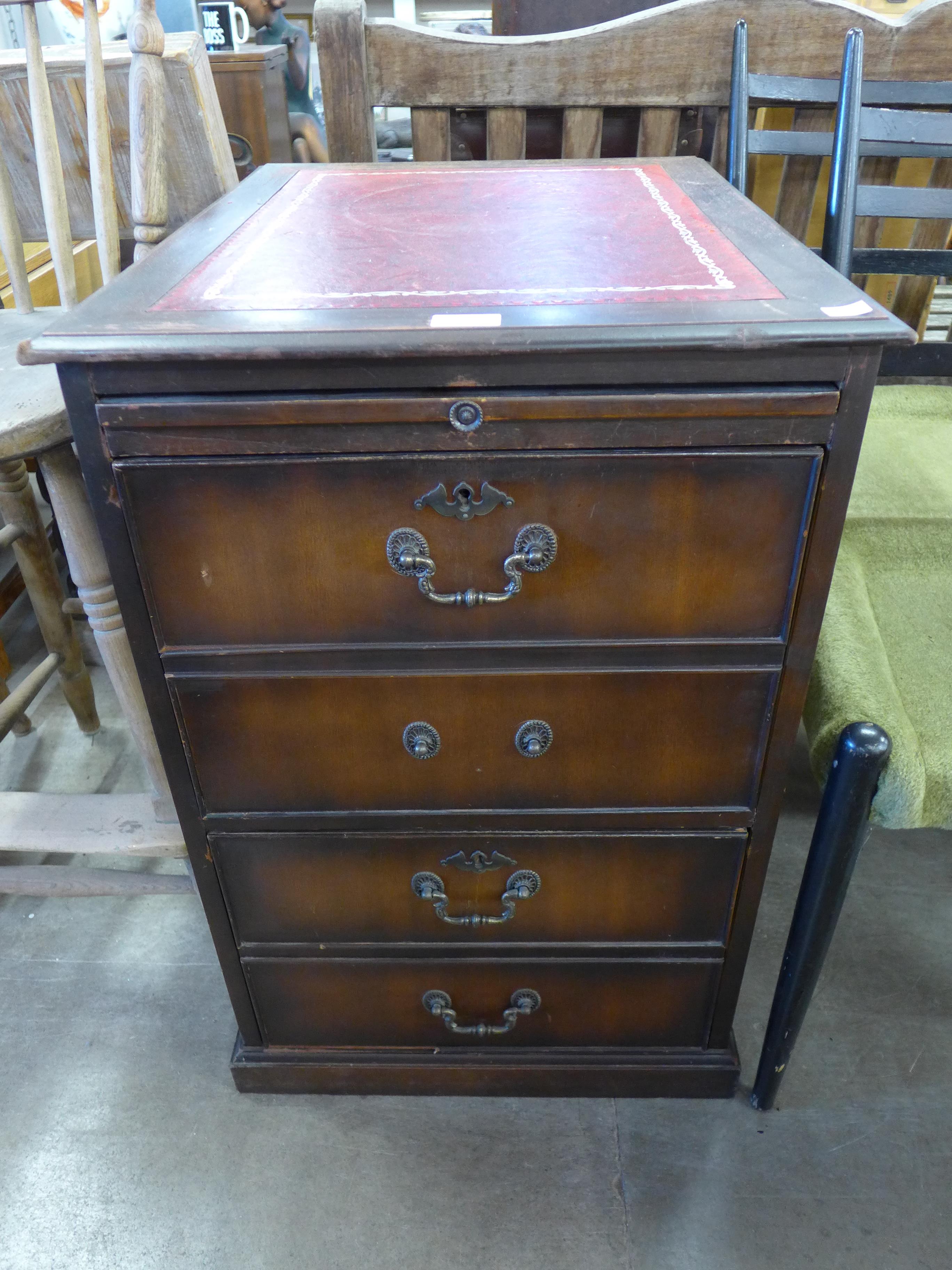 A mahogany and red leather topped filing cabinet