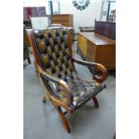 A Regency style mahogany and olive green buttoned leather armchair