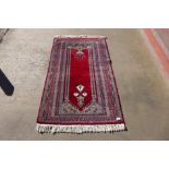 An eastern red ground rug, 155 x 94cms