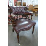 A mahogany and burgundy leather desk chair