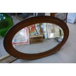 An Edward VII mahogany oval framed mirror