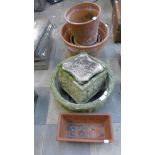 Assorted concrete and terracotta plant pots