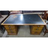 A Victorian mahogany and black leather topped library desk