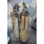 Two vintage golf bags with assorted golf clubs, including hickory shafted