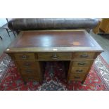 An Arts and Crafts mahogany pedestal desk