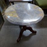 A marble topped tripod table