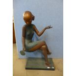 An Art Deco style bronze figure of a seated oriental lady with mirror