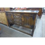 A carved oak linenfold dresser