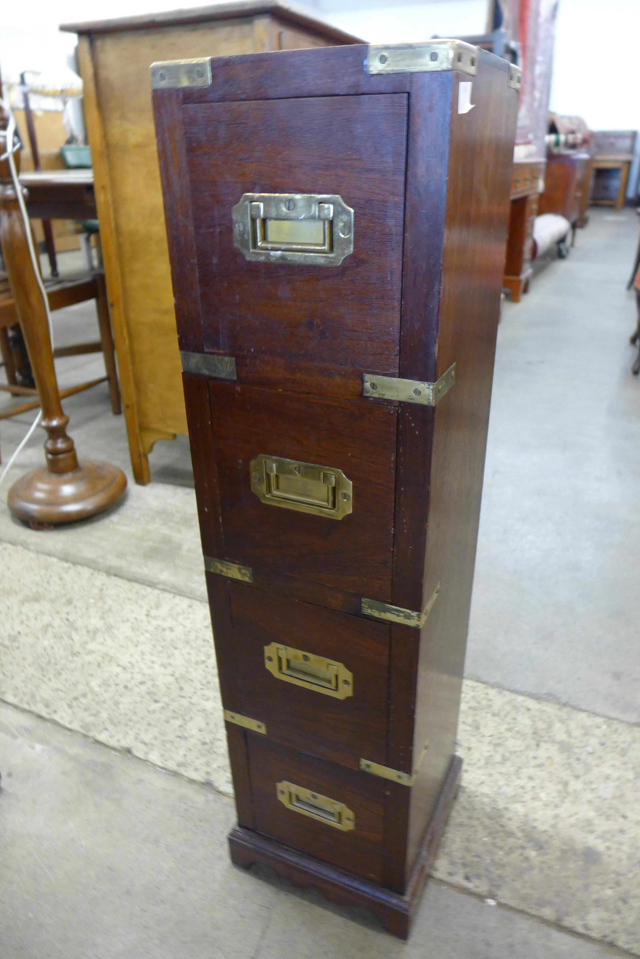 A small hardwood and brass mounted campaign style chest of drawers