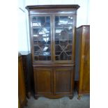 A George III oak freestanding splay front corner cabinet