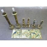 Assorted brass candlesticks and three tiles