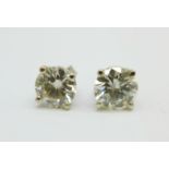 A pair of 14k white gold and diamond ear studs, each diamond approximately 1ct