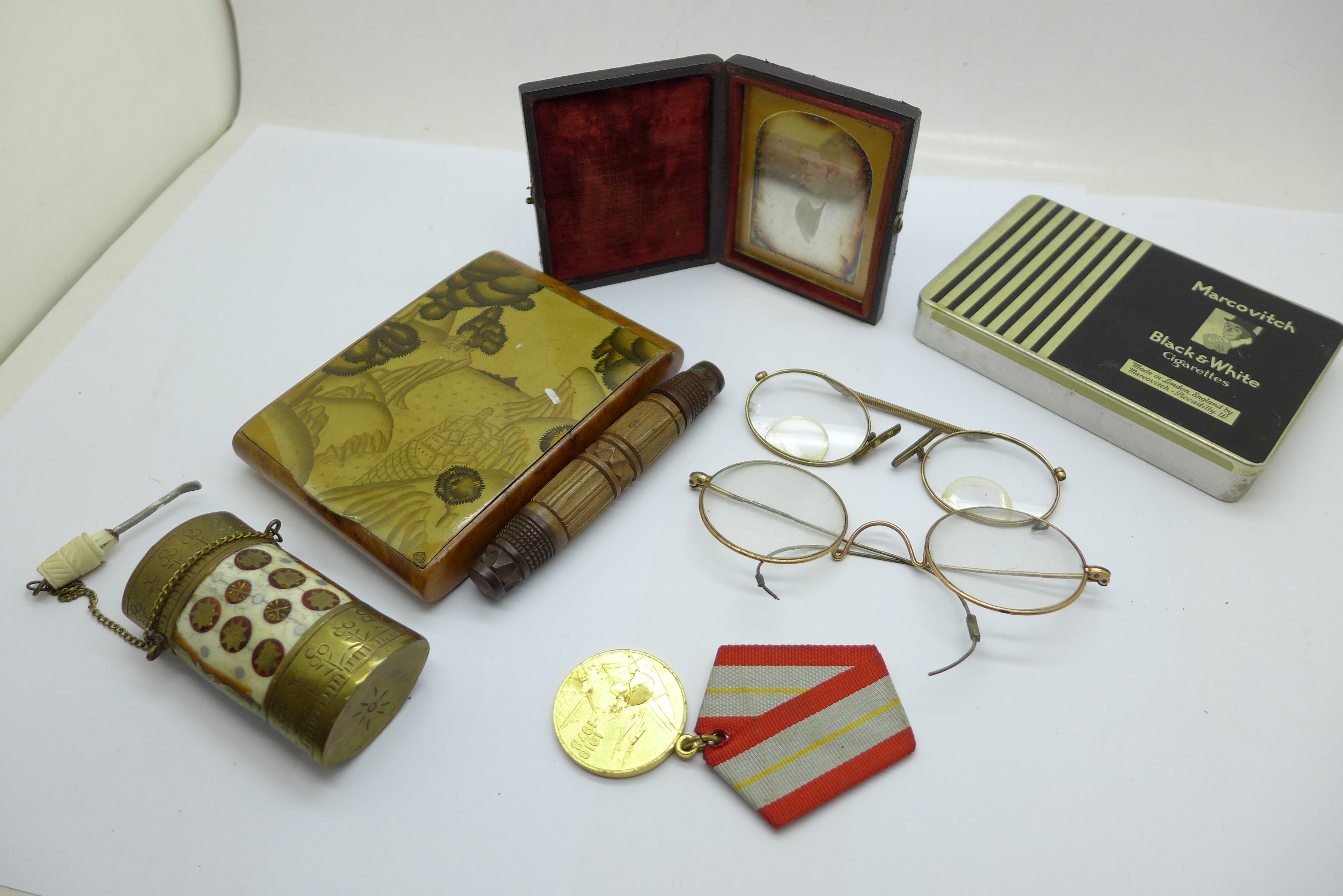 A Japanese cigarette case, a brass scent bottle, spectacles, a Russian medal, etc.