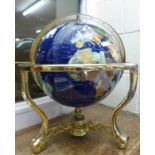A gem set globe on a brass stand