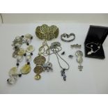 An elephant pendant on chain, two pairs of earrings and other necklaces and two brooches