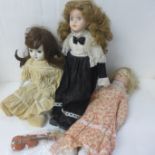 Three dolls with porcelain heads and limbs