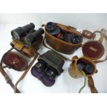 A pair of binoculars, two pairs of field glasses and a monocular, all cased