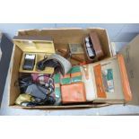 A box of miscellaneous items, Sine compass, travel vanity set, repro US police badges, pocket watch,