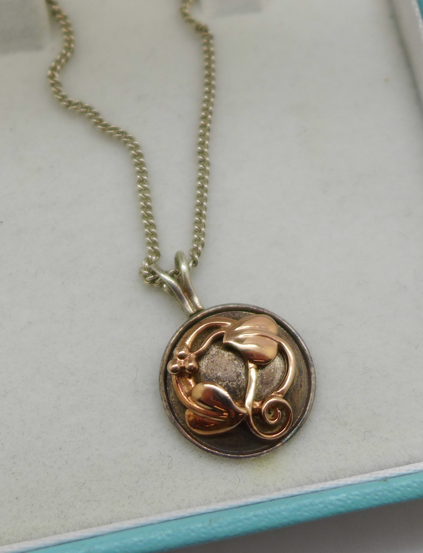 A Clogau silver pendant and chain with gold decoration