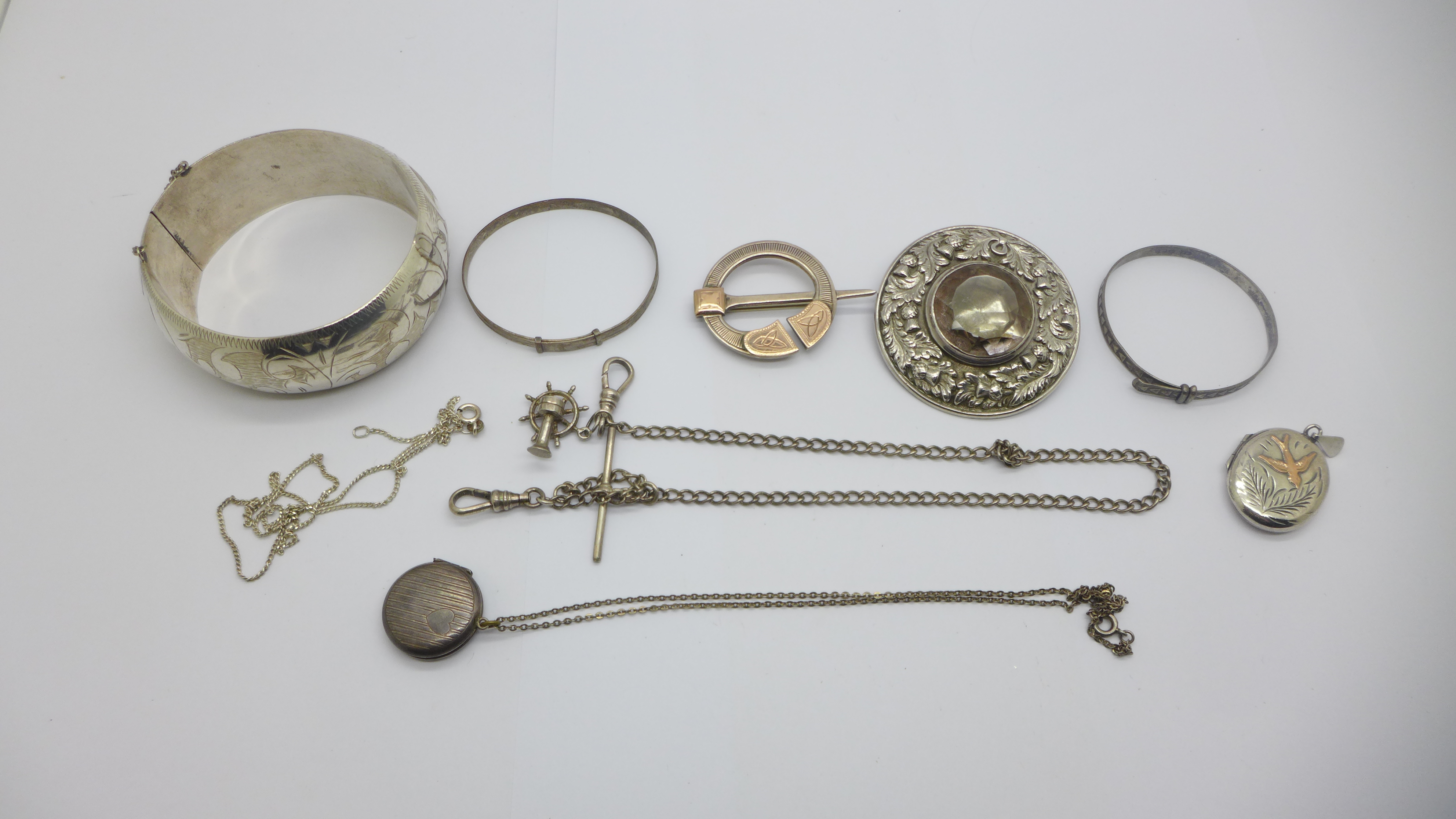 Silver jewellery including a Scottish brooch and a locket with gold applied decoration, 120g