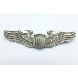 A WWII military silver USA pilot wings brooch, lacking pin