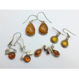 Four pairs of silver and amber earrings