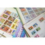 Three albums of stamps and a catalogue