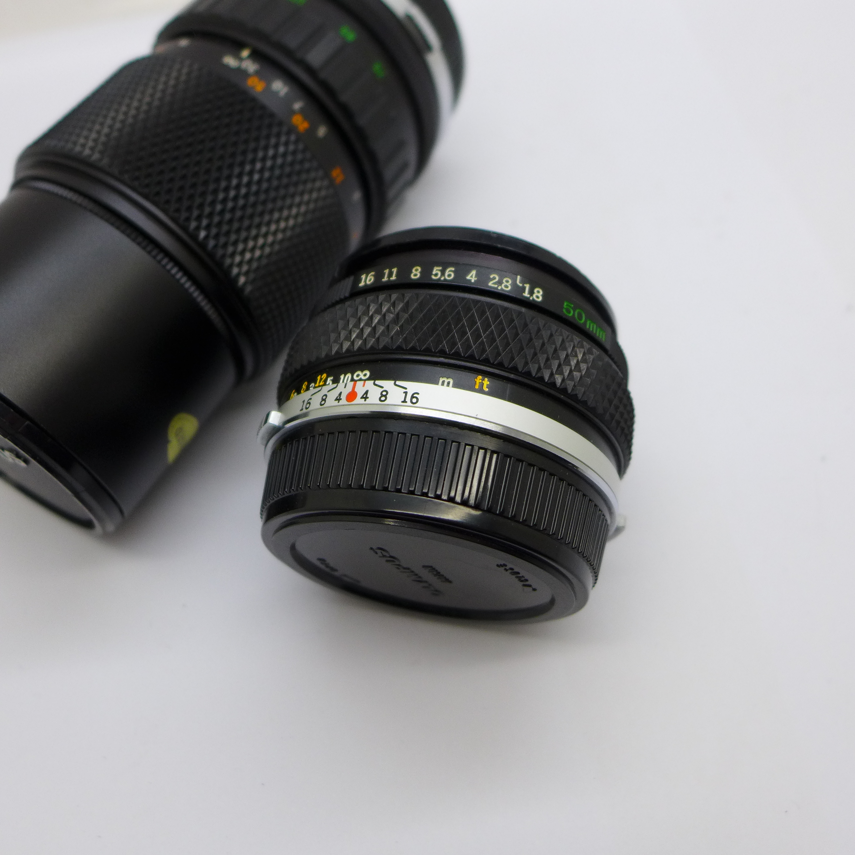 An Olympus f4 75-100mm and Zuiko Olympus f1.8 50mm Zuiko lenses, with caps - Image 2 of 5