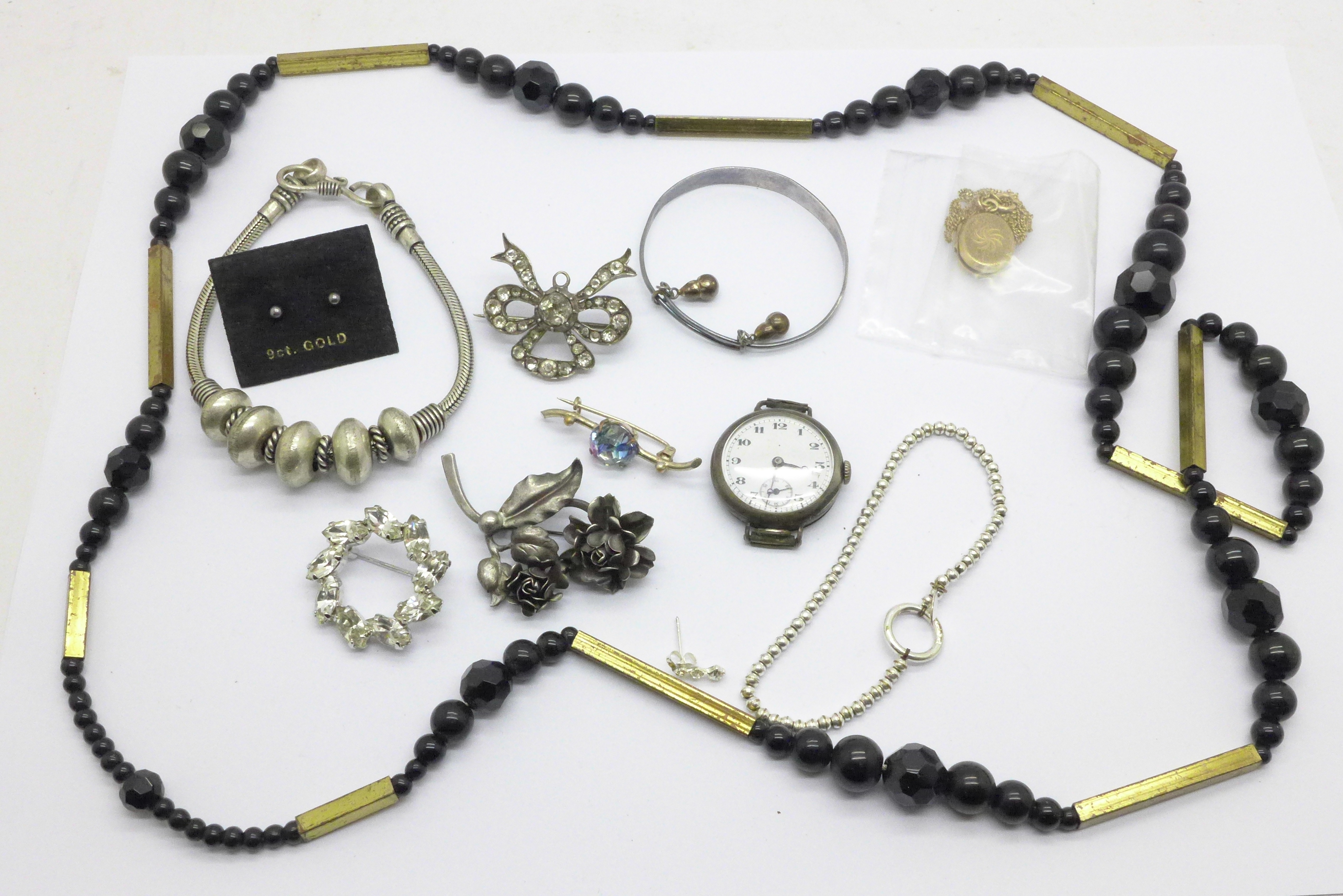 A 9ct gold back and front locket and chain, a silver bracelet, a silver watch and other jewellery