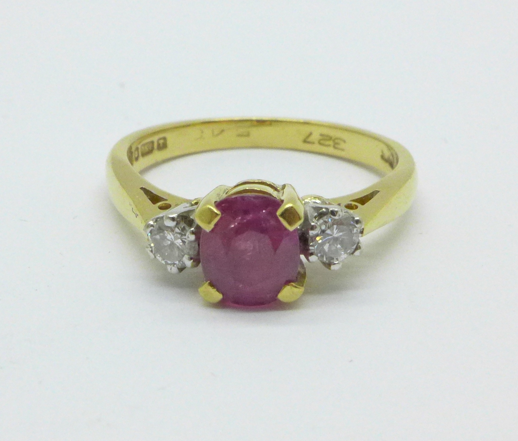 An 18ct ruby and diamond three stone ring, marked 18., 3.6g, M