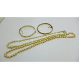 Two faux pearl necklaces with a 9ct gold clasp and two rolled gold bangles
