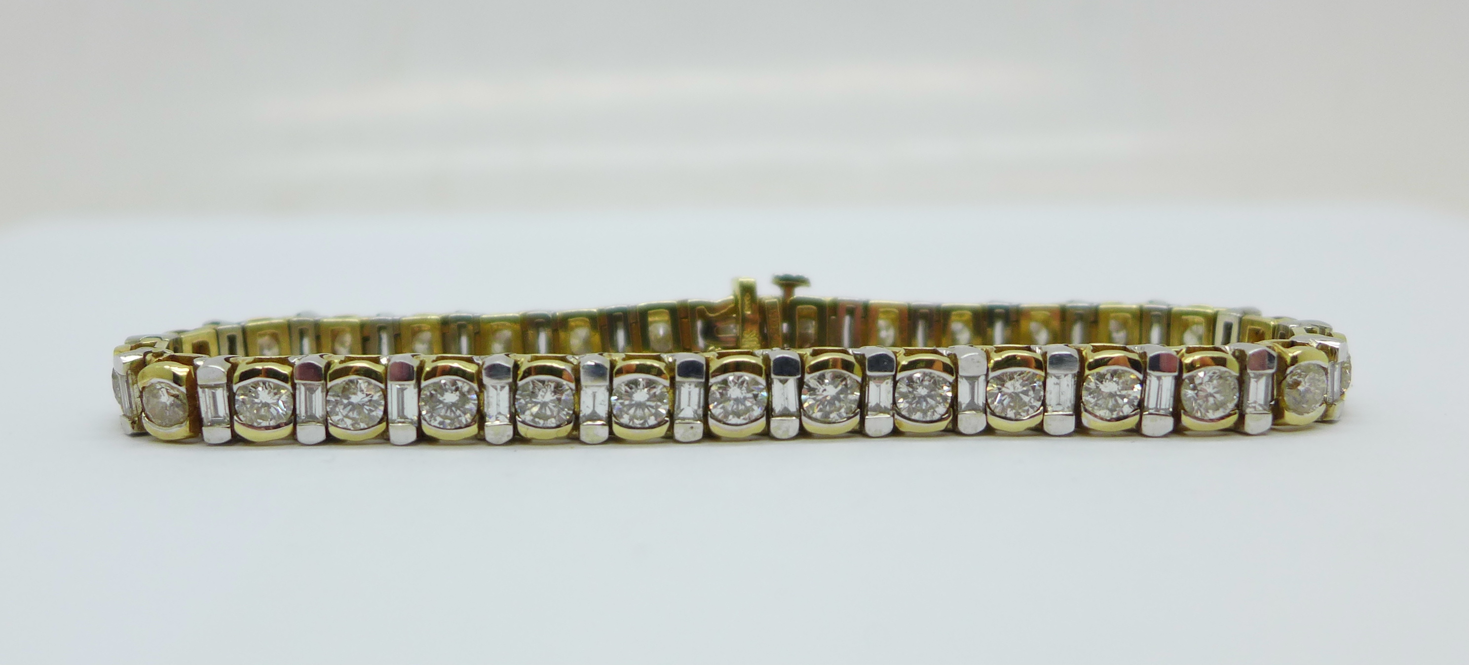 A 14k gold and diamond tennis bracelet with sixty diamonds, approximately 7ct diamond weight, 21.4g - Image 2 of 6