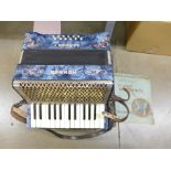 A Hohner Carmen I piano accordion with instruction manual