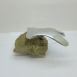 A Manta Ray car mascot mounted on a stone