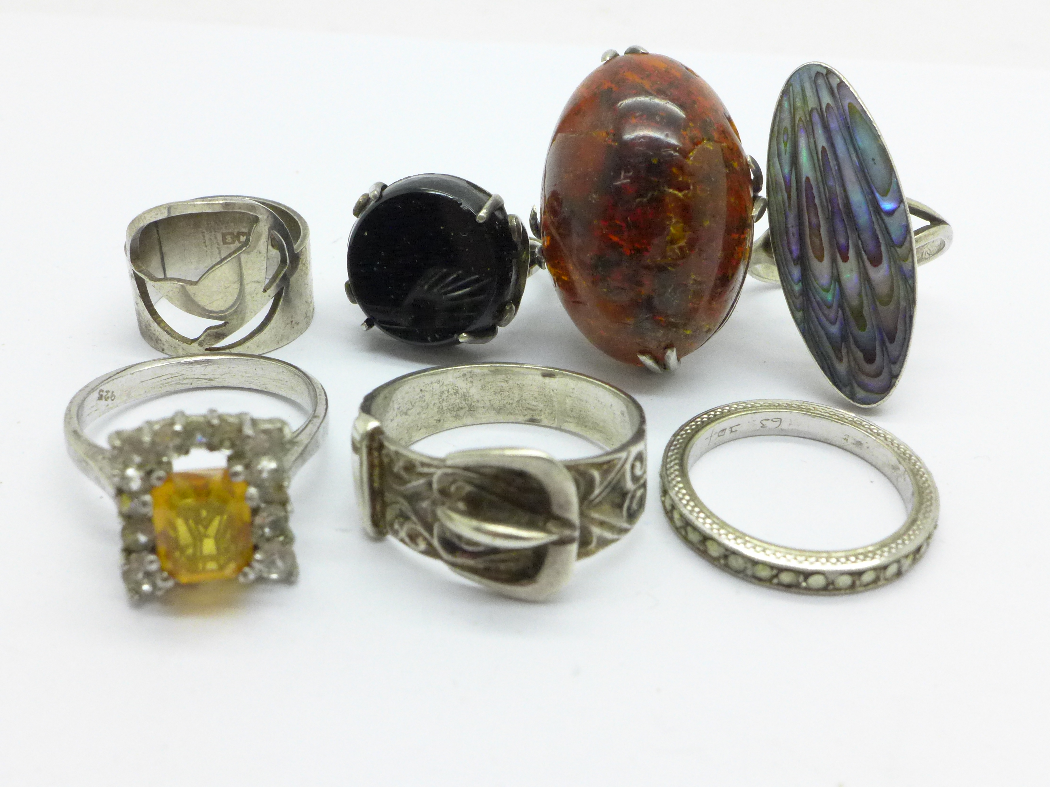 Seven silver rings, amber, etc.