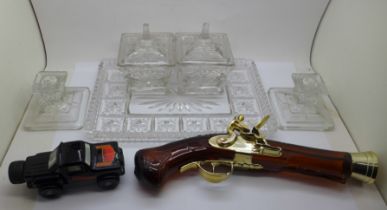 Two Avon novelty perfume bottles in the form of a car and a pistol, and a glass tray set